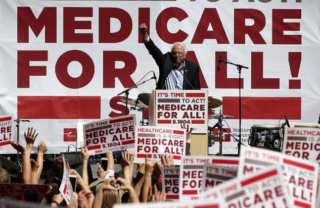 A rally with signs reading “Medicare for all,” showcasing grassroots advocacy.