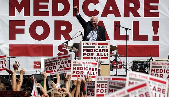 A rally with signs reading “Medicare for all,” showcasing grassroots advocacy.