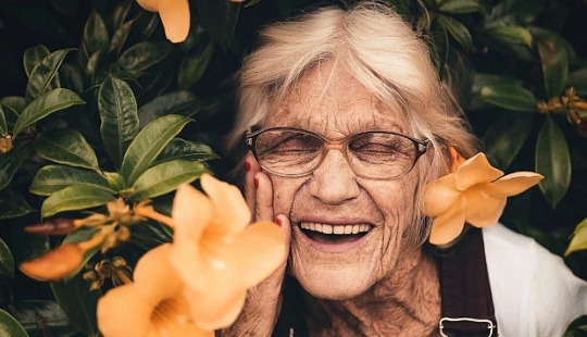 Elderly woman with bright smile symbolizing super aging and cognitive health